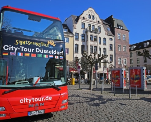 Düsseldorf,(burgplatz),,Germany,-,March,9.,2022:,View,On,Red Hop on hop off Bus in der Altstadt Düsseldorf